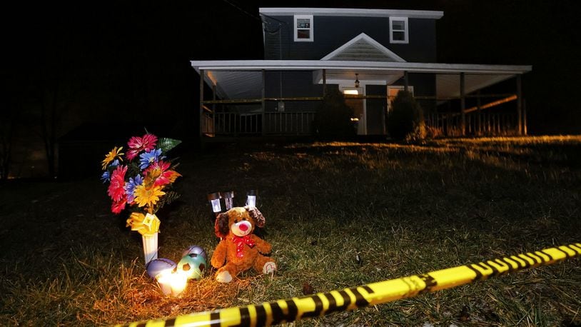 A memorial has been started in front of a house on Greenbush Road in Gratis Twp. where a man and his two children were found dead Monday, Jan. 24, 2022. NICK GRAHAM/STAFF