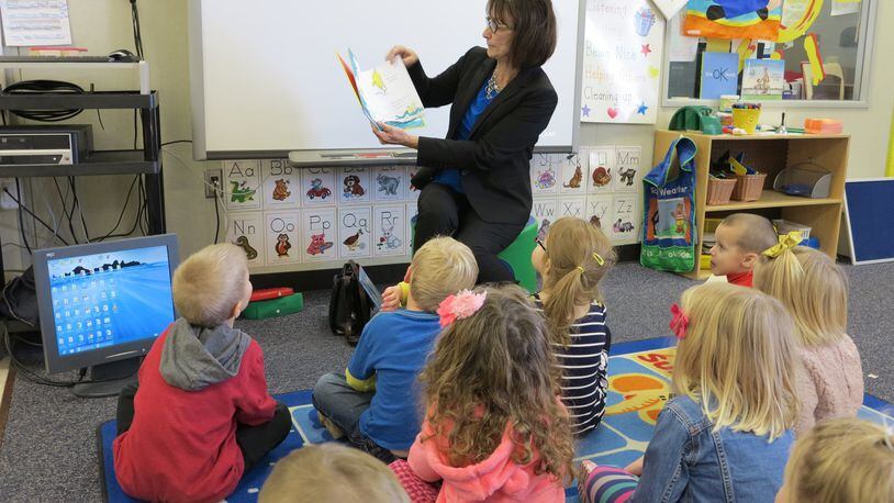 Warren County Career Center Superintendent Maggie Hess reads to preschoolers in WCCC’s state-licensed preschool, which offers hands-on learning experiences for high school students enrolled in the early childhood education program. CONTRIBUTED