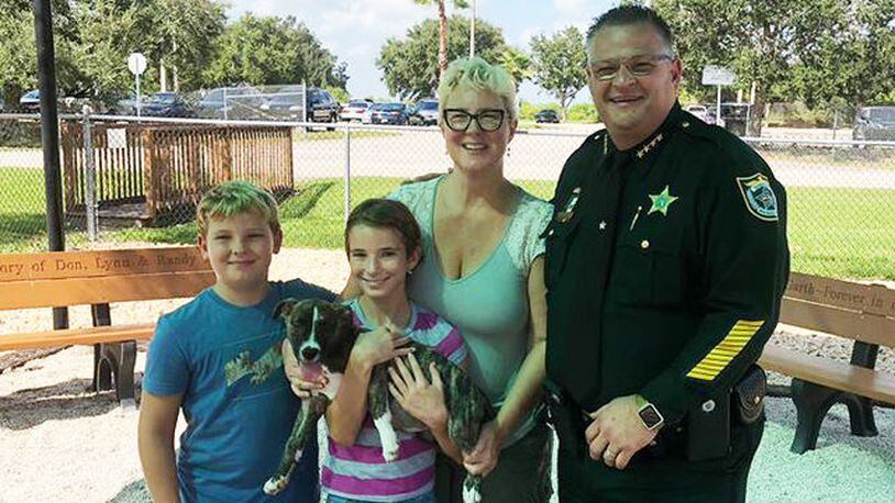 A family adopts a puppy they saved from a hot car outside a Merritt Island Walmart. (Photo: Brevard County Sheriff's Office)