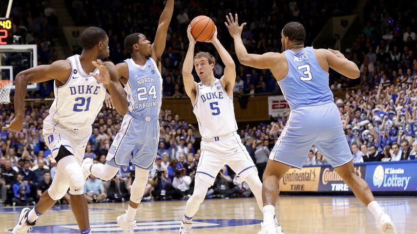 Duke’s Luke Kennard (5) looks to pass as Amile Jefferson (21) looks for the ball while North Carolina’s Kenny Williams (24) and Kennedy Meeks (3) defend during the first half of an NCAA college basketball game in Durham, N.C., Thursday, Feb. 9, 2017. (AP Photo/Gerry Broome)