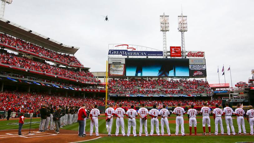 A helicopter flies over during the pre-game festivities of the Reds Opening Day game against the Pittsburgh Pirates at Great American Ballpark, Monday, Apr. 6, 2015. GREG LYNCH / STAFF