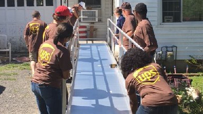 A Cincinnati non-profit, People Working Cooperatively, partnered with UPS last year to complete some projects for local homeowners in Middletown. Pictured are volunteers building a wheelchair ramp at a Middletown home. The group has received a $20,000 grant from the Middletown Community Foundation. CONTRIBUTED