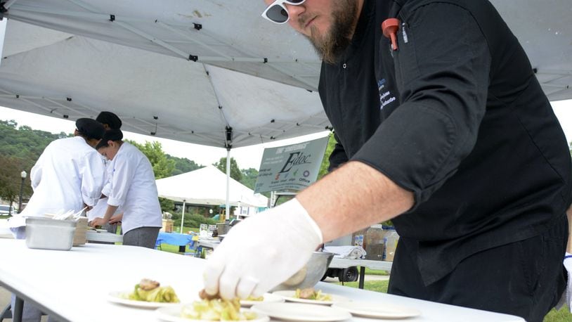 Chef Tyler Simpson, the instructor at Butler Tech culinary program at D. Russel Lee, brings rising seniors to the Village Green Farmers Market in Fairfield once a month to prepare items purchased that day at the market. Samples of the food are given away to patrons at the market. They were at the June 19 market preparing various dishes. MICHAEL D. PITMAN/STAFF