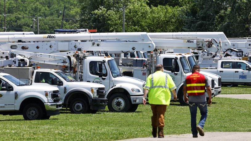 Duke Energy workers and their vehicles are seen at the Butler County Fairgrounds in Hamilton on Tues., June 14, 2022. The fairgrounds was a staging location for them as they worked throughout the region, including Butler and Warren counties, to restore power following severe storms that hit the area Monday. NICK GRAHAM/STAFF