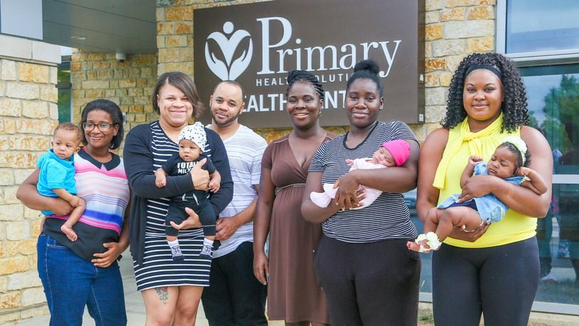 Mary Lockhart, Charman Hill, Nicholas Hill, Grace Eshun, Tiara Thomas and Sjone Hall, along with their children, took part n a PRIM Community Action Team event outside Primary Health Solutions Health Center in Middletown, Tuesday, Aug. 29, 2017. Th PRIM team - consisting of local community leaders, Pastors, advocates and concerned citizens are working together to combat Infant Mortality. GREG LYNCH / STAFF