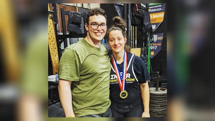 Christa Baumgartner is shown with her fiancé, Jake Dankert, at the amateur women’s weightlifting competition where she was credited with a total lift of 1,060 pounds for three events. CONTRIBUTED