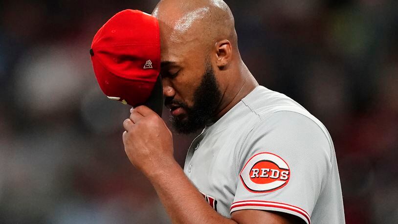Cincinnati Reds relief pitcher Amir Garrett takes a moment before working in relief during the sixth inning of the team's baseball game against the Atlanta Braves on Tuesday, Aug. 10, 2021, in Atlanta. (AP Photo/John Bazemore)