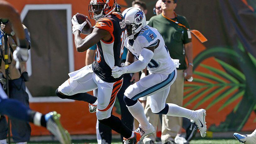 CINCINNATI, OH - SEPTEMBER 21: Jason McCourty #30 of the Tennessee Titans tackles A.J. Green #18 of the Cincinnati Bengals during the first quarter at Paul Brown Stadium on September 21, 2014 in Cincinnati, Ohio. (Photo by Andy Lyons/Getty Images)