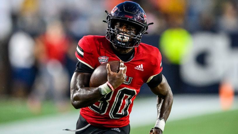 Northern Illinois running back Harrison Waylee (30) runs toward the end zone for a touchdown during the first half of an NCAA college football game against Georgia Tech on Saturday, Sept. 4, 2021, in Atlanta. (AP Photo/Danny Karnik)