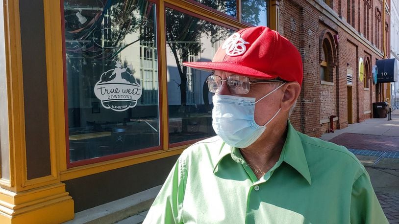 Vernon Burge, 60, from Hamilton, wears a mask as he rides his bike along High Street Wednesday, July 8, 2020 in Hamilton. Burge is for the mask ordinance set forth by Govnernor Dewine in counties with level 3 or level for public health emergency status. NICK GRAHAM / STAFF