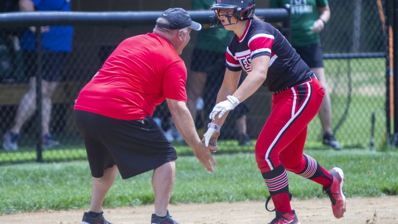 Lakota West's KK Mathis celebrates her first-inning home run with Firebirds coach Keith Castner during Thursday's Division I regional semifinal vs. Mason at Centerville High School. Jeff Gilbert/CONTRIBUTED