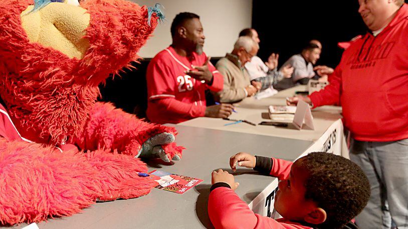 Ricky Brown, 5, gets an autograph from Gapper as his father, Chris Brown, speaks with Dmitri Young as the Reds Caravan made a stop at Miami University’s Hamilton campus Staurday, Jan. 28, 2017. Contributed Photo / E.L. Hubbard