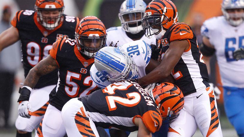 CINCINNATI, OH - DECEMBER 24: William Jackson #22, Clayton Fejedelem #42 and Brandon Bell #52 of the Cincinnati Bengals tackle Tion Green #38 of the Detroit Lions during the second half at Paul Brown Stadium on December 24, 2017 in Cincinnati, Ohio. (Photo by Joe Robbins/Getty Images)