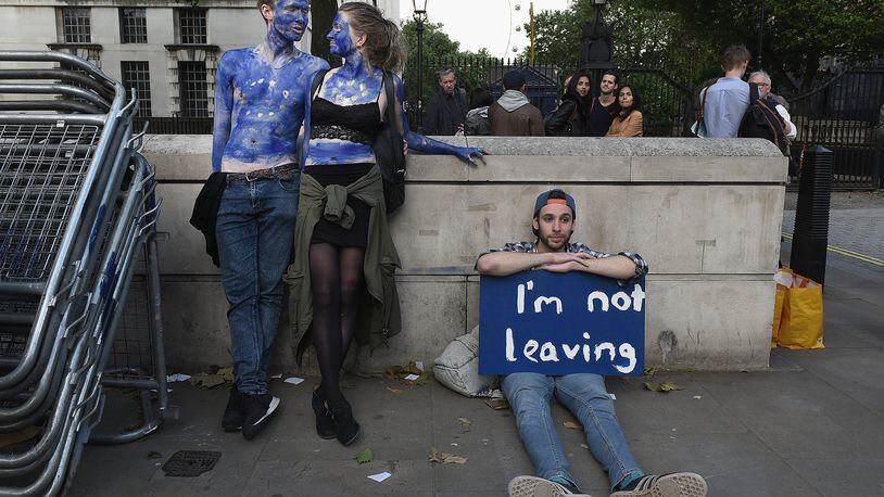LONDON, ENGLAND- JUNE 24: A young couple painted as EU flags protest on outside Downing Street against the United Kingdom's decision to leave the EU following the referendum on June 24, 2016 in London, United Kingdom. The United Kingdom has gone to the polls to decide whether or not the country wishes to remain within the European Union. After a hard fought campaign from both REMAIN and LEAVE the vote is too close to call. A result on the referendum is expected on Friday morning. (Photo by Mary Turner/Getty Images)