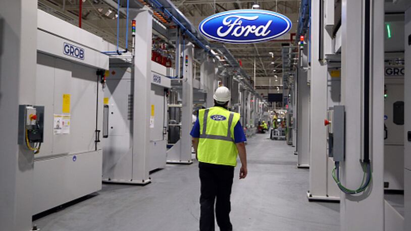 DAGENHAM, ENGLAND - JANUARY 13:  An employee walks past a Ford logo in the yet-to-be-completed engine production line at a Ford factory on January 13, 2015 in Dagenham, England. Originally opened in 1931, the Ford factory has unveiled a state of the art GBP475 million production line that will start manufacturing the new low-emission, Ford diesel engines from this November this will generate more than 300 new jobs, Ford currently employs around 3000 at the plant in Dagenham.  (Photo by Carl Court/Getty Images)