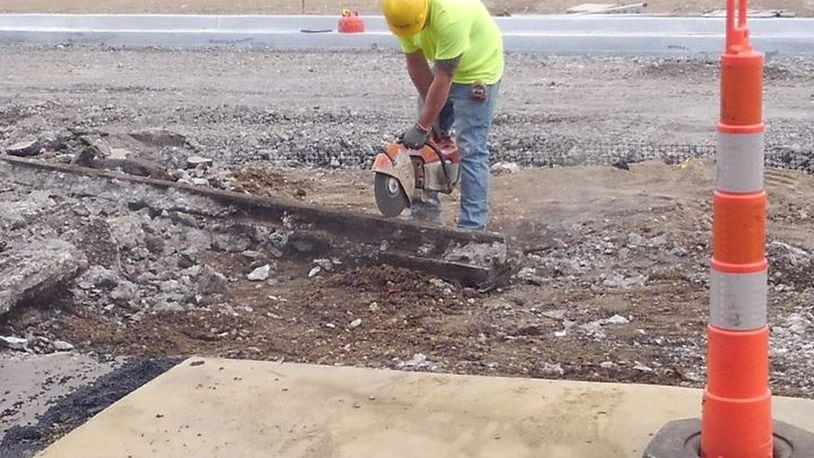 While crews were preparing part of Main Street in Hamilton for repaving, they were surprised to find old trolley tracks beneath the roadway. Segments were cut out to be given to the Butler County Historical Society. PROVIDED