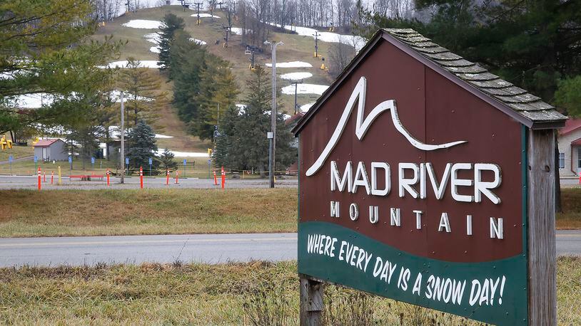 The sign outside Logan County's Mad River Mountain reads "Where Every Day is a Snow Day!" Tuesday, Dec. 26, 2023. With temperatures in the mid 50s Tuesday, there was no "Snow Day" at the ski resort. BILL LACKEY/STAFF