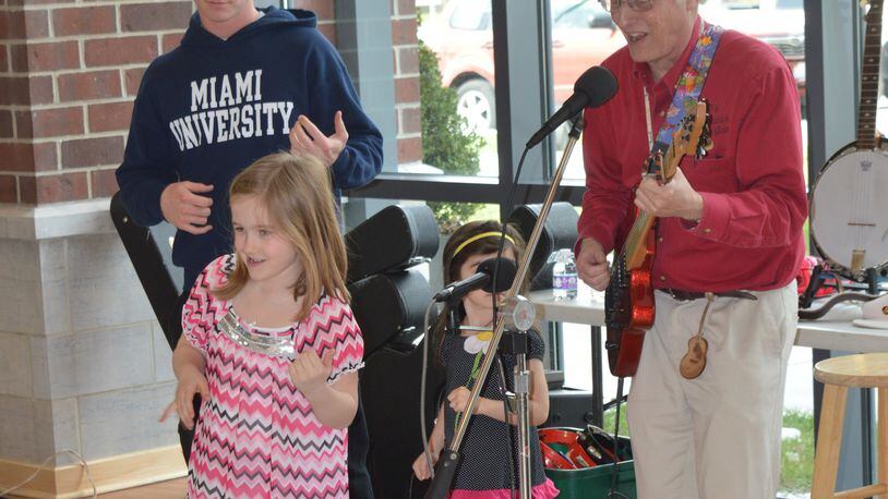 No library card is needed to check out an air guitar, and young library patrons joined the fun as Jim McCutcheon (aka “The Guitar Man”) entertained March 5 to kick off the library’s new musical instrument lending program. CONTRIBUTED/BOB RATTERMAN