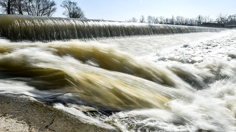 Water flows over the low level dam on the Great Miami River at Combs Park in Hamilton.