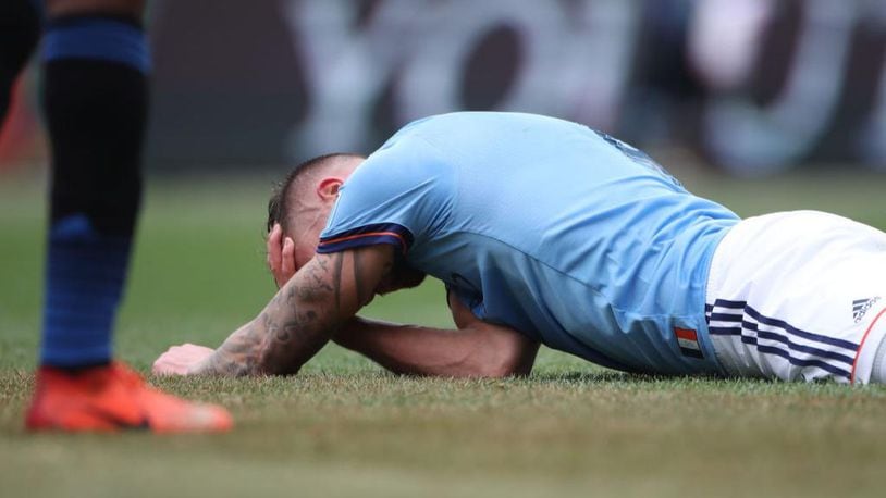 Maxime Chanot of New York City FC holds his head after a clash of heads form a corner kick during a game last year. Researchers say even mild concussions can increase risks for dementia.