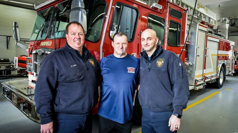 Duane Sparks (middle) with Fairfield firefighter paramedics Rob Lance (left) and Scott Goller (right) at the Fairifield Fire Department headquarters on Nilles Road. Sparks has developed a special relationship with the Fairfield Fire Department.