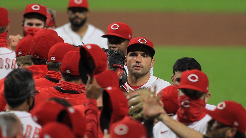 The Reds celebrate a victory against the Indians on Monday, Aug. 3, 2020, at Great American Ball Park in Cincinnati. David Jablonski/Staff