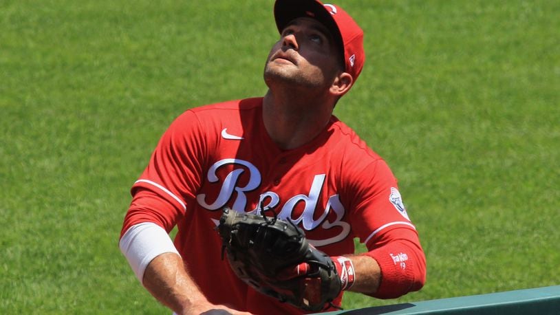 Reds first baseman Joey Votto chases a foul ball during a game against the Tigers on Sunday, July 26, 2020, at Great American Ball Park in Cincinnati. David Jablonski/Staff