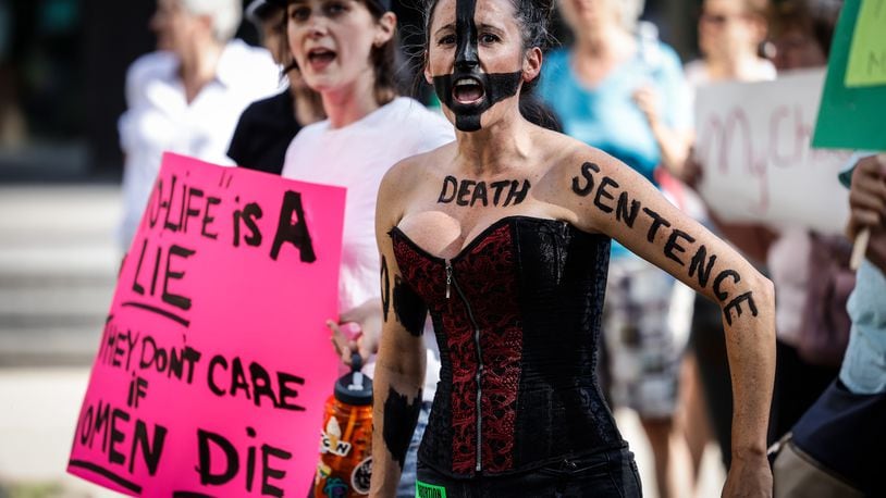 Brittany Bojorquez, of Dayton, wearing black body paint, is among a group of about 200 abortion rights supporters who gathered Friday evening, June 24, 2022, on the lawn of the Walter H. Rice Federal Building on Second Street in downtown Dayton after Roe v. Wade was overturned by the U.S. Supreme Court. JIM NOELKER/STAFF