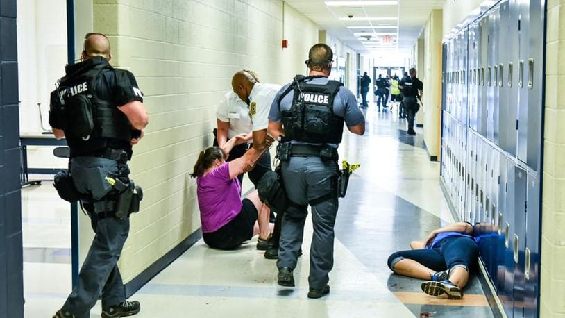 Hamilton High School and the city’s police department conducted a mock, active-shooter attack earlier this summer on the school campus in preparation for upgrading security in the coming school year. NICK GRAHAM/STAFF