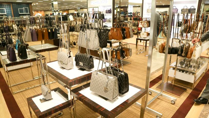 Michael Kors designed purses on display during a media preview for the new 2 floor, 160,000-square-foot Dillard’s store at Liberty Center, Wednesday, Sept. 30, 2015. GREG LYNCH / STAFF