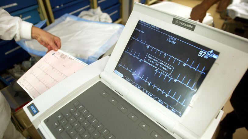 A nurse prints out an EKG monitor reading in an emergency room at a hospital.