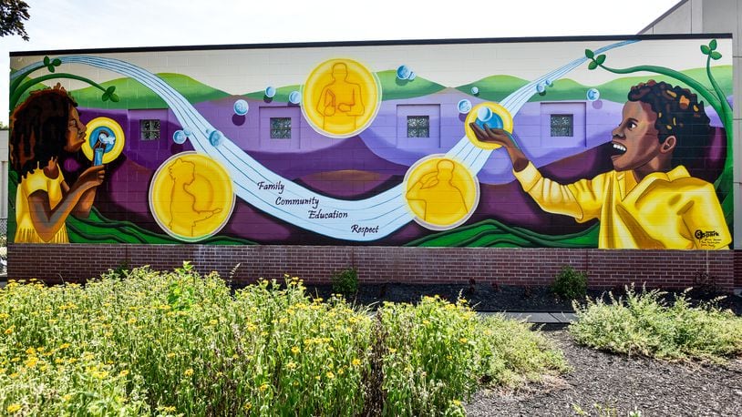 The 2019 StreetSpark mural titled " Inspiring the Future" is completed on the front of the Booker T. Washington Community Center on S. Front Street in Hamilton. The mural was designed by Jamie Schorsch. NICK GRAHAM/STAFF
