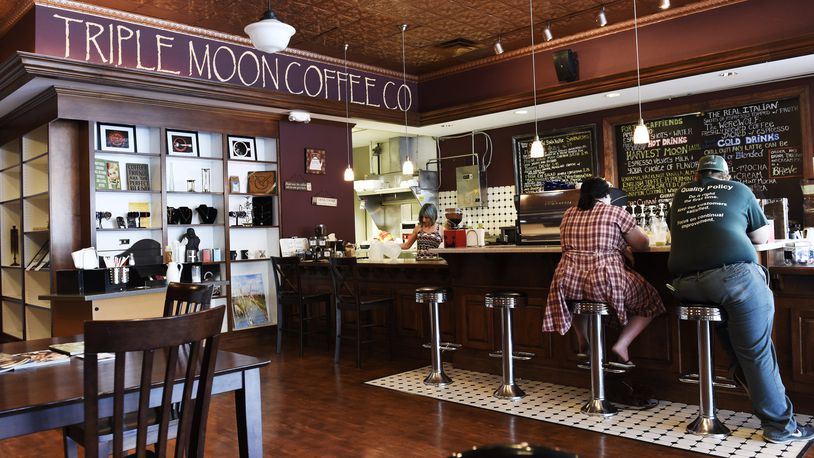 Customers sit at the counter at Triple Moon Coffee Company in Middletown. NICK GRAHAM/2015