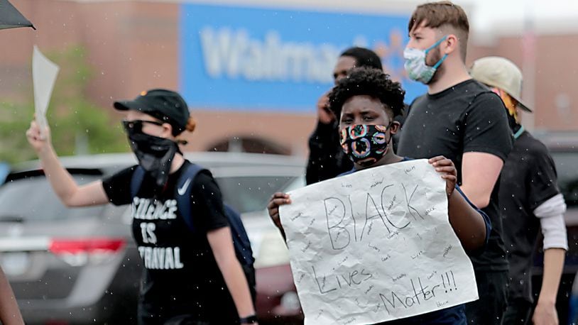 Hundreds of people gathered for a Solution Movement peaceful march and protest in front of the Beavercreek Walmart Saturday, June 13, 2020. E.L. Hubbard for the Dayton Daily News
