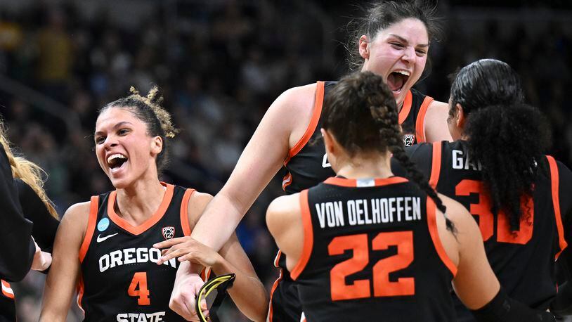 Oregon State players celebrate after defeating Notre Dame in a Sweet Sixteen round college basketball game during the NCAA Tournament, Friday, March 29, 2024, in Albany, N.Y. (AP Photo/Hans Pennink)