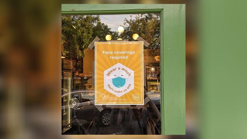Signs such as this one on the door of La Bodega restaurant, 11 W. High St., were distributed through the city to businesses all over town after city council passed a mask mandate. OXFORD OBSERVER