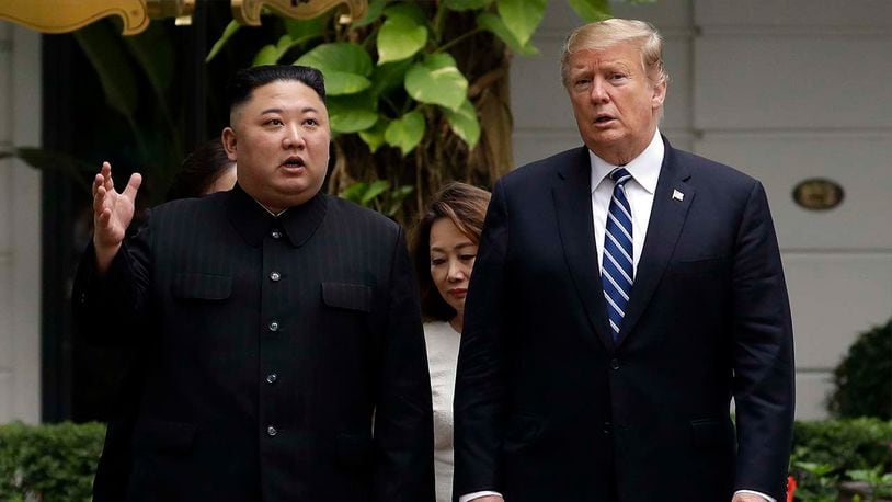 In this Feb. 28, 2019, file photo, U.S. President Donald Trump and North Korean leader Kim Jong Un take a walk after their first meeting at the Sofitel Legend Metropole Hanoi hotel, in Hanoi, Vietnam. South Korea's president Moon Jae-in on Tuesday, June 25, 2019, said North Korean and U.S. officials are holding "behind-the-scenes talks" to set up a third summit between the countries' leaders.