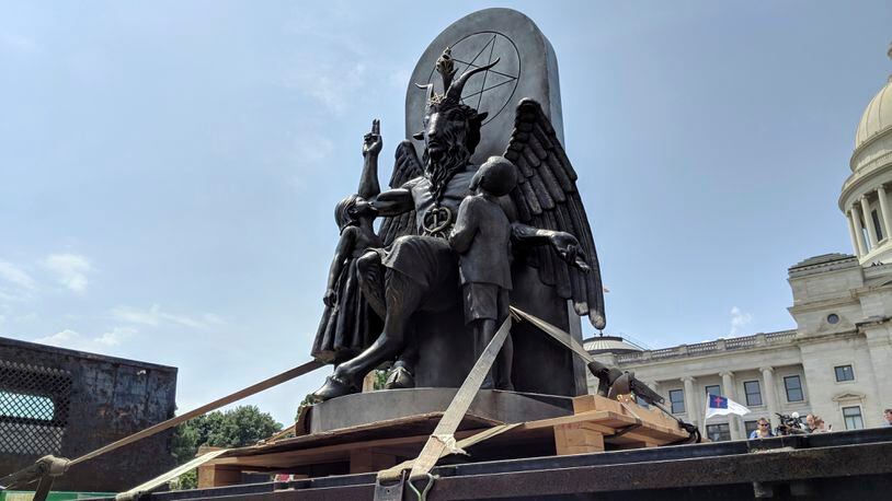 The Satanic Temple unveiled its statue of Baphomet, a winged-goat creature, at a rally for the first amendment in Little Rock, Ark., Thursday, Aug. 16, 2018. The Satanic Temple wants to install the statue on Capitol grounds as a symbol for religious freedom after a monument of the Biblical Ten Commandments was installed in 2017.