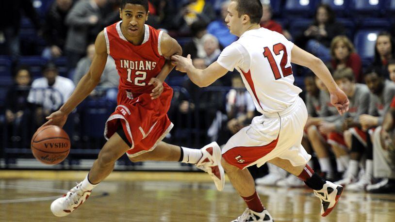 Fairfield’s Tim Fleming dribbles around La Salle’s Chris Rodriguez during their Division I sectional game against Xavier University’s Cintas Center on March 3, 2012. The Indians won 35-30. JOURNAL-NEWS FILE PHOTO