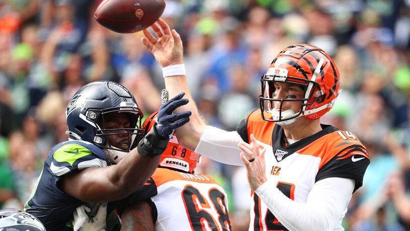 SEATTLE, WASHINGTON - SEPTEMBER 08: Andy Dalton #14 of the Cincinnati Bengals throws the ball against Rasheem Green #98 of the Seattle Seahawks in the second quarter during their game at CenturyLink Field on September 08, 2019 in Seattle, Washington. (Photo by Abbie Parr/Getty Images)