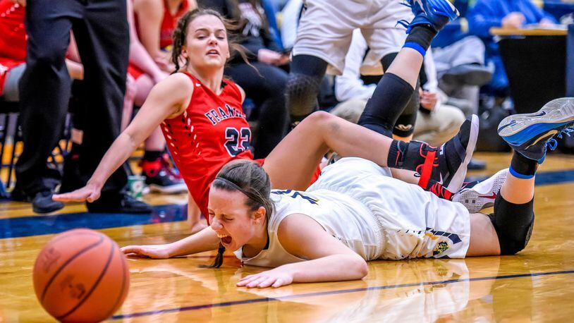 Franklin's Jessica King (22) and Monroe's Katie Sloneker fall to the ground as they fight for a ball during their game Thursday, Dec. 15 at Monroe High School in Monroe. NICK GRAHAM/STAFF