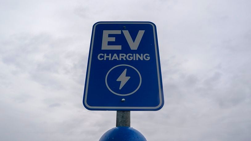 FILE - A sign sits at an electric vehicle charging station, March 8, 2024, at an electric vehicle charging station in London, Ohio. A new poll from The Associated Press-NORC Center for Public Affairs Research shows that 45% of adults in the United States say they have become more concerned about climate change over the past year, including roughly 6 in 10 Democrats and one-quarter of Republicans. (AP Photo/Joshua A. Bickel, File)