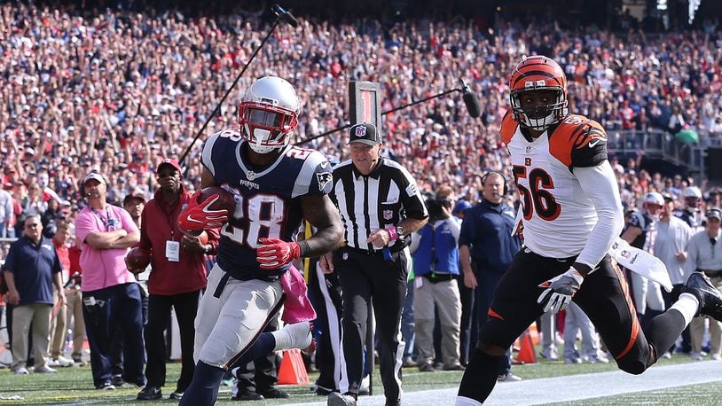 FOXBORO, MA - OCTOBER 16: James White #28 of the New England Patriots runs the ball by Karlos Dansby #56 of the Cincinnati Bengals for a touchdown in the second quarter at Gillette Stadium on October 16, 2016 in Foxboro, Massachusetts. (Photo by Jim Rogash/Getty Images)