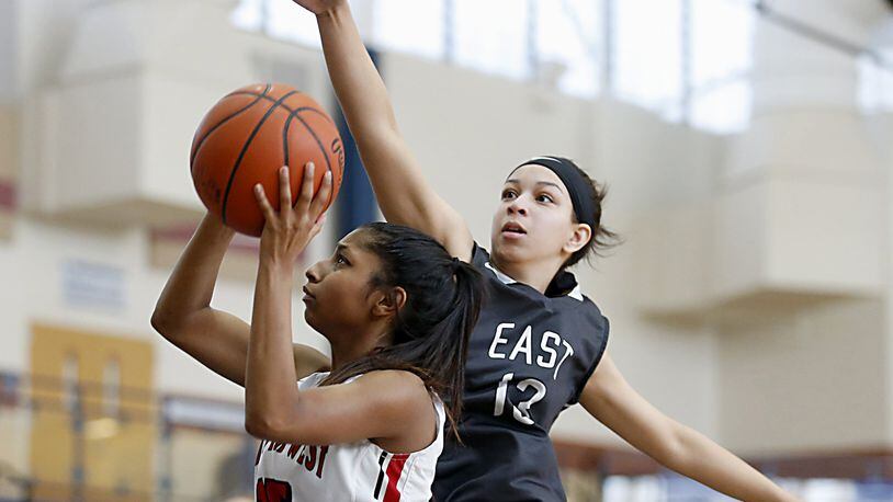 Lakota West guard Bryana Henderson heads to the basket as Lakota East guard Jordan Stanley tries to block the shot during the All-Butler County All-Star girls basketball game at the Hamilton Athletic Center on Saturday afternoon. CONTRIBUTED PHOTO BY E.L. HUBBARD