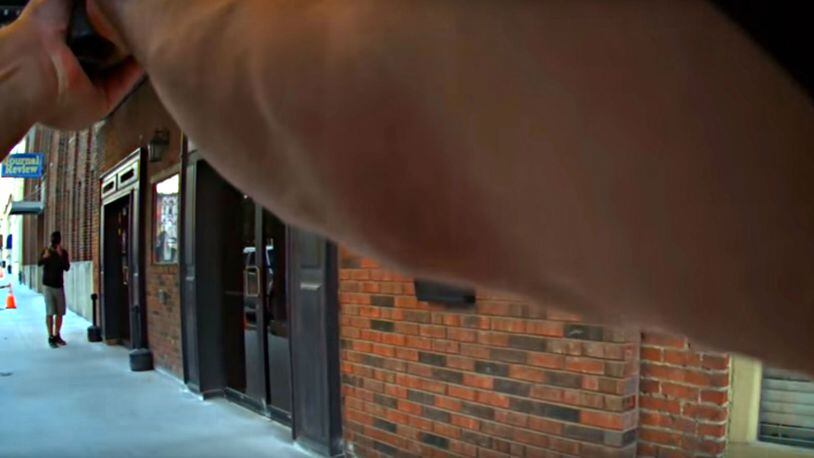 A screenshot taken from body camera footage shows a Crawfordsville, Indiana, police officer confronting a man wearing a ski mask and holding a gun outside a bar on Sept. 26, 2017. The man, identified by police as actor Jim Duff, was shooting a robbery scene for a movie.