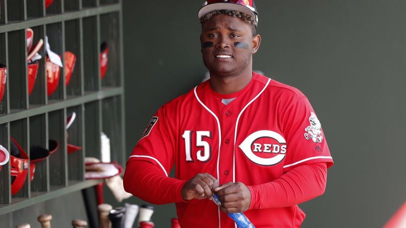 Cincinnati Reds’ Dilson Herrera walks in the dugout before a spring training baseball game against the Kansas City Royals, Wednesday, Feb. 28, 2018, in Surprise, Ariz. (AP Photo/Charlie Neibergall)