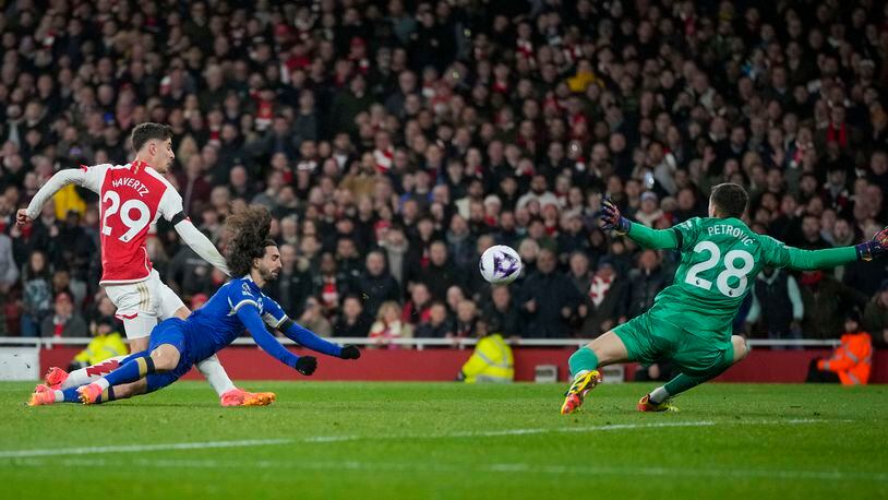 Arsenal's Kai Havertz, left, scores his side's third goal during the English Premier League soccer match between Arsenal and Chelsea at Emirates Stadium in London, Tuesday, April 23, 2024. (AP Photo/Kin Cheung)