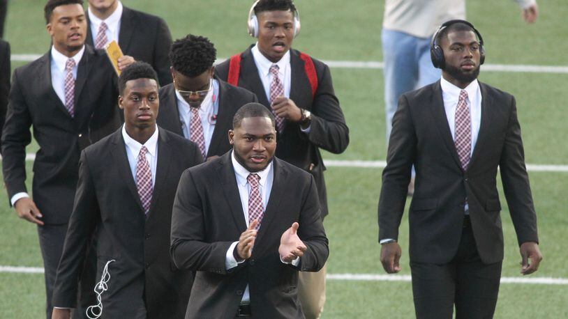 Ohio State players, including Tyquan Lewis, front center, and J.T. Barrett, right, arrive at Ohio Stadium before a game against Nebraska on Saturday, Nov. 5, 2016, in Columbus. David Jablonski/Staff