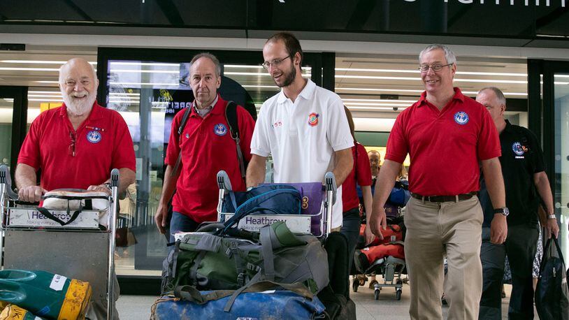 FILE PHOTO: Diver Josh Bratchley, centre, from the rescue mission, which helped to save 12 schoolboys and their soccer coach from a flooded cave in Thailand, arrives back at London's Heathrow Airport.