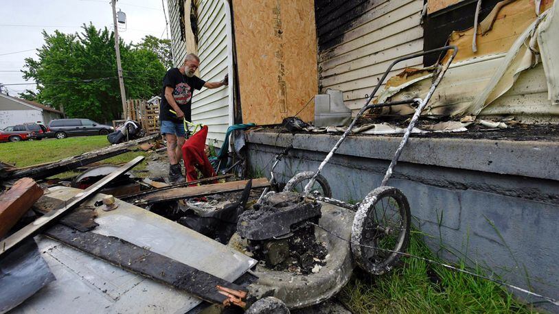 Jim Humphrey looks over the damage after a fire Wednesday night, May 10, at his home on Ludlow Street in Hamilton. He says in the four months he has lived at the home, he has often had to run vandals off the property.